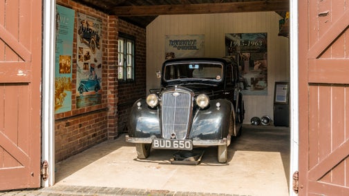 Lady Nuffield's Wolseley car inside a brown-painted garage at Nuffield Place, Oxfordshire